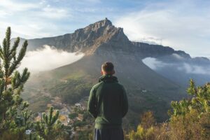 Hiker looking at Table Mountain from Lions Head