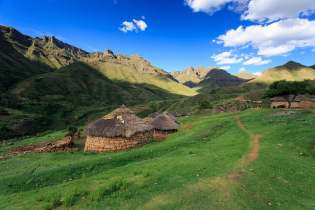 Drakensberg huts with donkeys at foot of mountainous region