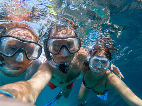 Snorkeling friends taking underwater selfie in the sea