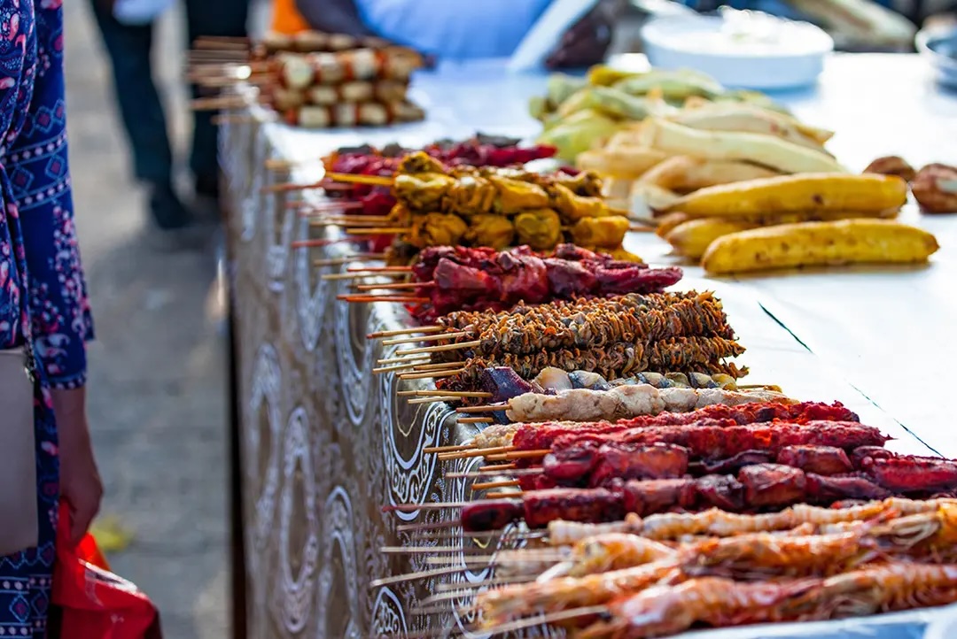 Seafood skewers laid on table at food market Zanzibar.